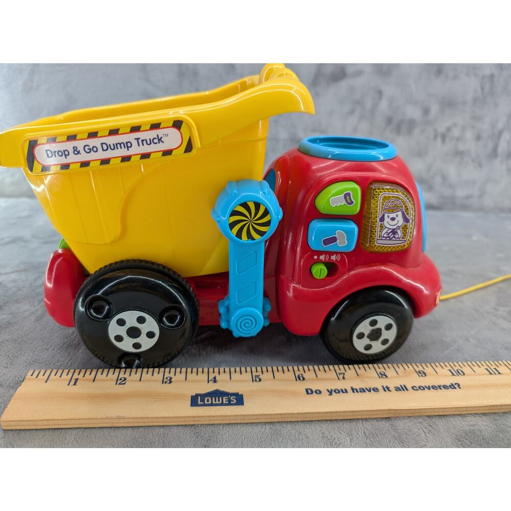 Drop & go dump pull truck Vtech 2 balls plays music & lights up